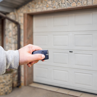 Muncie security key fob pointing to a garage door